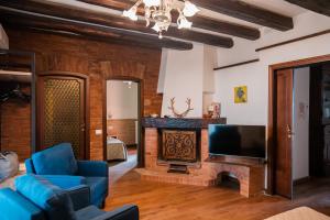 a living room with a fireplace and a tv at Villa La Pieve in Città della Pieve