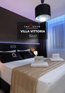 a hotel room with a bed with two towels on it at VILLA VITTORIA in Luxembourg