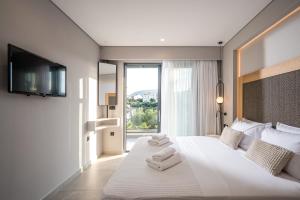 A bed or beds in a room at Aida Luxury Villas