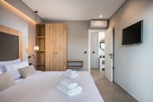 A bed or beds in a room at Aida Luxury Villas