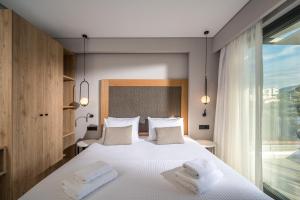 A bed or beds in a room at Aida Luxury Villas