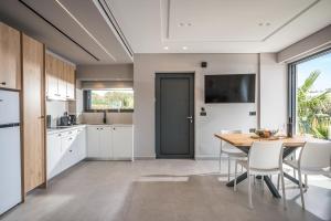 A kitchen or kitchenette at Aida Luxury Villas