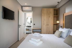 A bed or beds in a room at Aida Luxury Villas