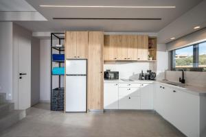 A kitchen or kitchenette at Aida Luxury Villas