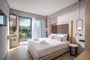 A bed or beds in a room at Aida Luxury Villas
