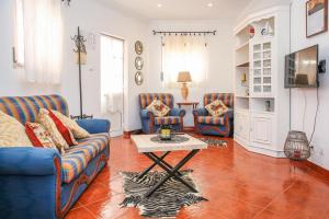 uma sala de estar com dois sofás azuis e uma mesa em Villa House Vasco da Gama - Pool & BQQ - Pata da Gaivota na Lourinhã