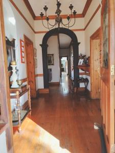 an archway in a room with a wooden floor at Oregon Place Guest House in Middelburg