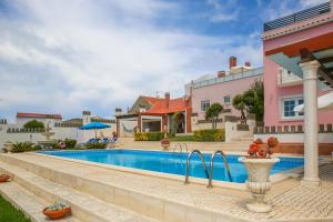 a villa with a swimming pool and a house at Apartamento Vasco da Gama - Pool & BQQ - Pata da Gaivota in Lourinhã