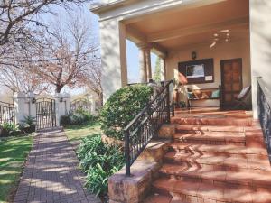 a house with a staircase leading to the front door at Oregon Place Guest House in Middelburg