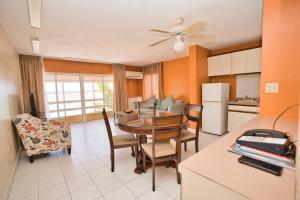 a kitchen and dining room with a table and chairs at Horizon View Beach Hotel in Philipsburg
