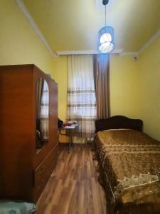 a bedroom with a bed and a dresser and a window at Villa In Urekhi in Batumi