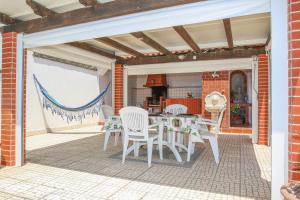 a patio with a table and chairs on it at Villa House Vasco da Gama - Pool & BQQ - Pata da Gaivota in Lourinhã