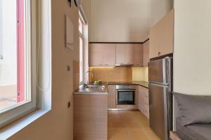 a small kitchen with a sink and a refrigerator at Filomeli Estate in Chania Town