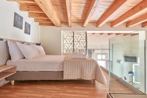 a bedroom with a bed and a glass wall at Filomeli Estate in Chania Town