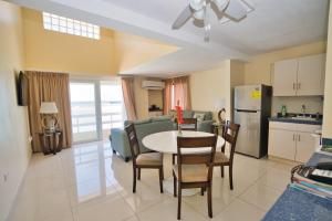 a kitchen and living room with a table and chairs at Horizon View Beach Hotel in Philipsburg