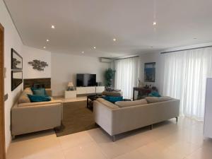 a living room with two couches and a television at Casa de praia in Manta Rota