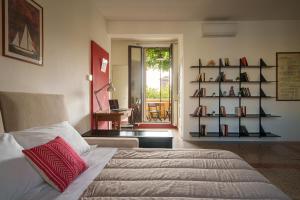 a bedroom with a bed and a living room with a table at Accomodo Milano - MIB13 Bivano Navigli in Milan