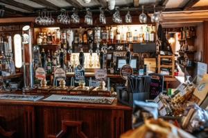 a bar with a lot of bottles of alcohol at The Mortal Man Inn in Troutbeck