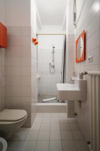 a bathroom with a toilet and a sink and a shower at Accomodo MIB13 Bivano Navigli in Milan
