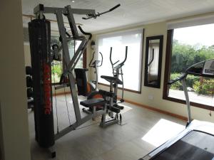 a gym with two tread machines in a room at Cabañas Kurumamell in Sierra de los Padres