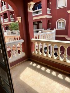 a balcony of a house with white railings at Apartamento PUERTO in Mazagón