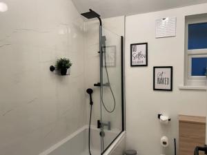 a shower with a glass door in a bathroom at The Marlborough by M-GroupSA in Swansea