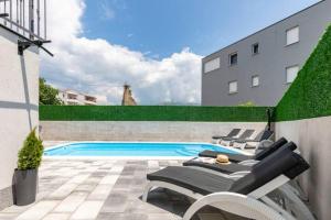 a swimming pool in the backyard of a building at Holiday home Split in Split