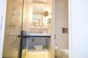a bathroom with a sink and a shower at Thalazur Ouistreham - Hôtel & Spa in Ouistreham