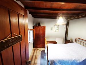 a bedroom with a bed and a sign on the door at Abrigo das Penhas in Manteigas