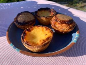 a blue plate with three muffins on a table at Abrigo das Penhas in Manteigas