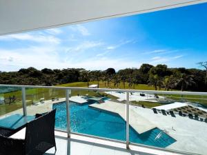 a balcony with a view of a swimming pool at Bala Bliss in Colón