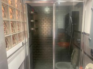 a bathroom with a glass shower with a toilet at Be Your Home - Grazioso monolocale tra porto e stazione in Civitavecchia