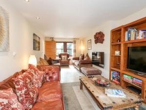 a living room with a couch and a coffee table at The Lillies in Great Rowsley