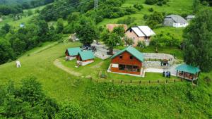 an aerial view of a house on a green hill at Etno selo ŽURIĆ in Mojkovac