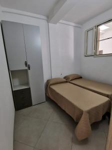 a small bedroom with a bed and a window at Appartamenti da Matteo in Peschici