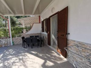 a patio with a table and chairs and a staircase at Appartamenti da Matteo in Peschici