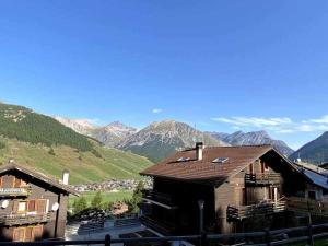a group of buildings with mountains in the background at Appartamento Gnomo Livigno in Livigno