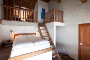 a bedroom with two bunk beds and a ladder at Langley Hotel La Vieille Ferme in La Salle Les Alpes