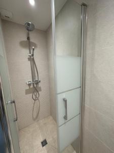 a shower with a glass door in a bathroom at Residencecalou in Saint-Gervais-les-Bains +11 photos