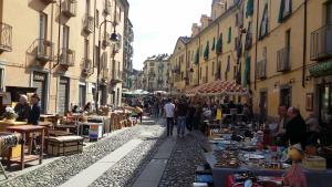 a group of people walking down a street with a market at Hotel Dora in Turin
