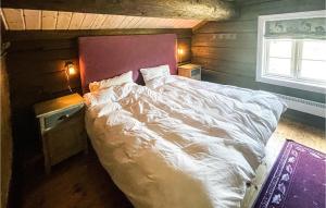 a bedroom with a white bed and a window at Beautiful Home In Uvdal With Sauna, Wifi And 5 Bedrooms in Dagali