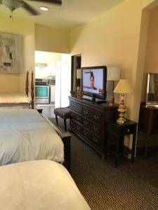 a hotel room with a television on a dresser at 1/F 2 bed rooms in Pittsburgh