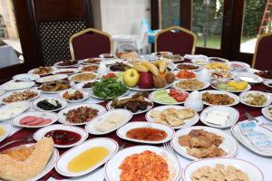 a table with many plates of food on it at Elruha Hotel in Sanlıurfa