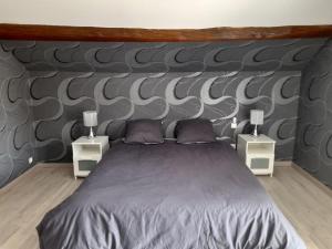 a bedroom with a large bed with two night stands at Vallée du Serein in Marcilly-Ogny