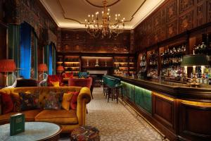 a living room with a bar and a couch at Grantley Hall in Ripon