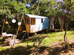 an old train car parked in a yard at Domaine de Bourbacoup in Tulle