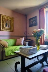 ein Wohnzimmer mit einem Sofa und einem Tisch mit Büchern in der Unterkunft Monastery Cottage in Rye