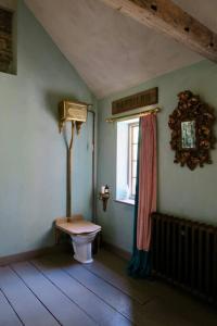 a bathroom with a toilet and a window at Monastery Cottage in Rye