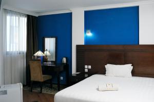 Łóżko lub łóżka w pokoju w obiekcie Central Hotel Tana