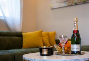 a bottle of wine and a glass on a table at Aqua Casa in Vrnjačka Banja